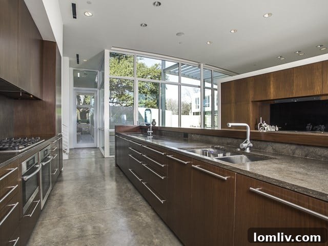 The gourmet kitchen featuring modern appliances and elegant finishes, including white limestone counters.