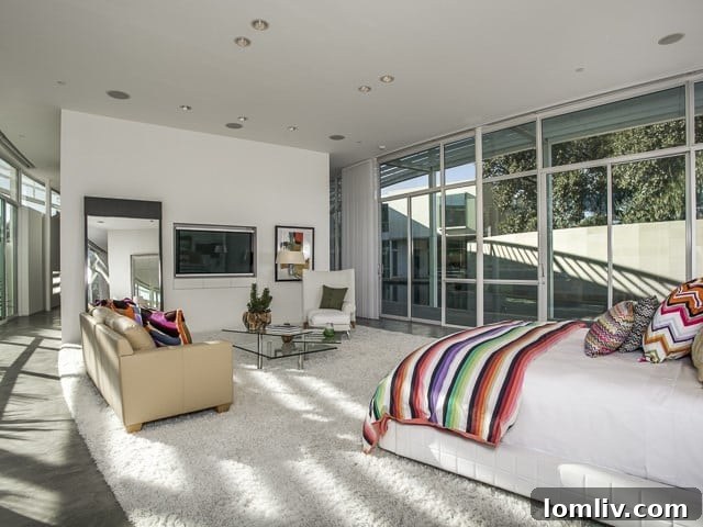 Another view of the master bedroom, highlighting its expansive space and modern aesthetic.