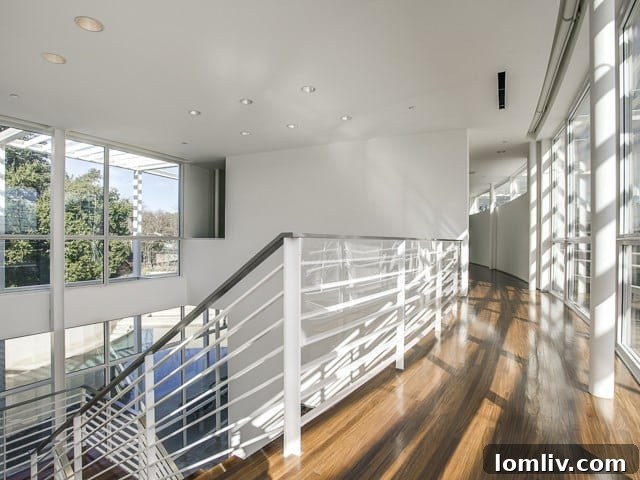 The elegant upper landing, featuring warm Aframosia wood and seamless architectural details.