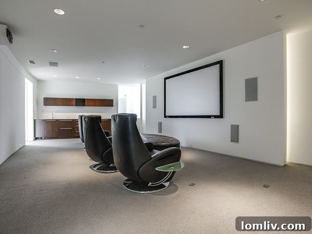 Another view of the media room, highlighting its comfortable seating and immersive setup.