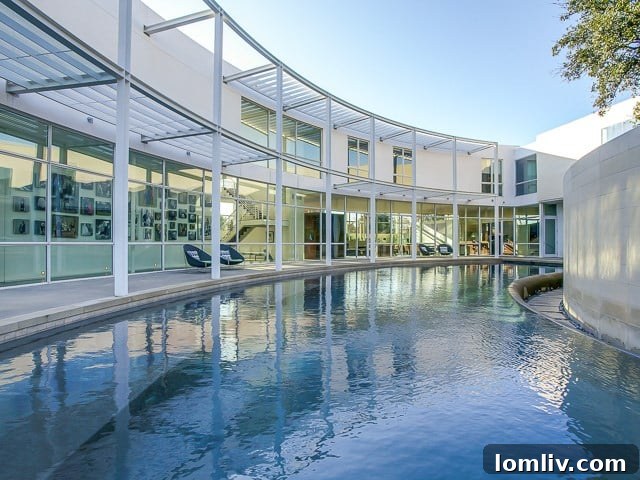 An aerial view showcasing the sparkling pool and elegant outdoor living spaces at 6645 Northaven.