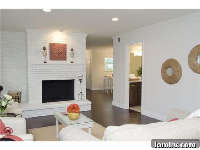 Stunning Lake Highlands Remodel Showcases a Custom Kitchen 4 Elegant Living Room with Modern Fireplace and Dark Wood Floors