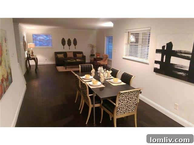 Open Concept Living and Dining Area with Dark Floors at 9937 Larchbrook