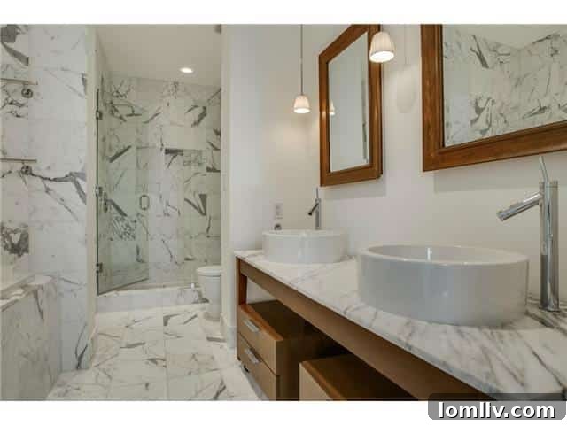 The House Master Bath - A lavish master bathroom featuring marble finishes, double vanities, and a walk-in shower.