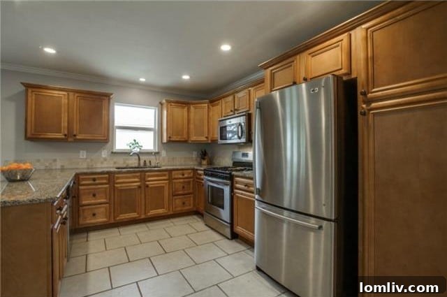Midcentury Marvel: East Dallas Ranchette's Compact Power 11 Kitchen view showing tile flooring and modern fixtures