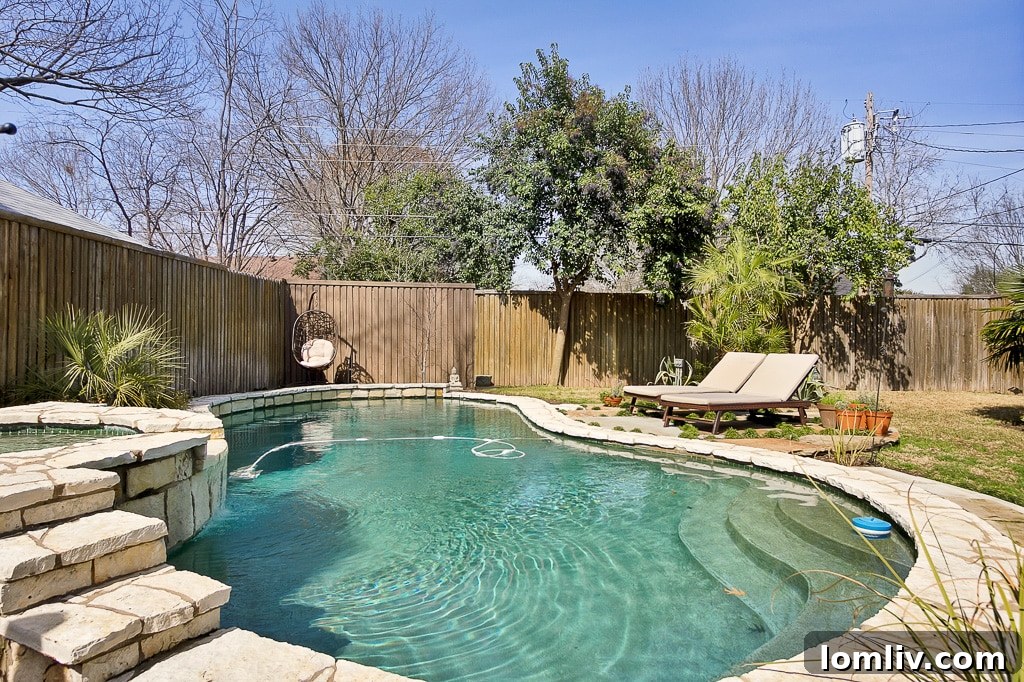 Charming East Dallas Tudor Gem Won't Last Long 18 An aerial view of the property's backyard, showing the pool and surrounding landscaped area.