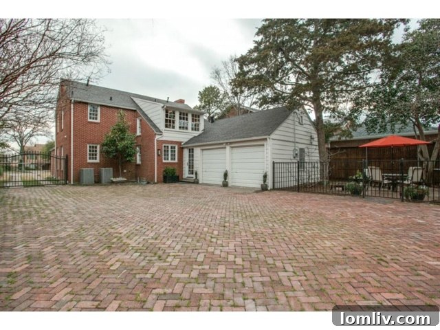 Gated driveway and attached two-car garage of 6827 Gaston Avenue