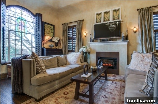 The sophisticated and inviting living room of Stacey Warnix's Hollywood Heights Tudor, featuring a blend of original architectural elements and contemporary furnishings, creating a timeless appeal.