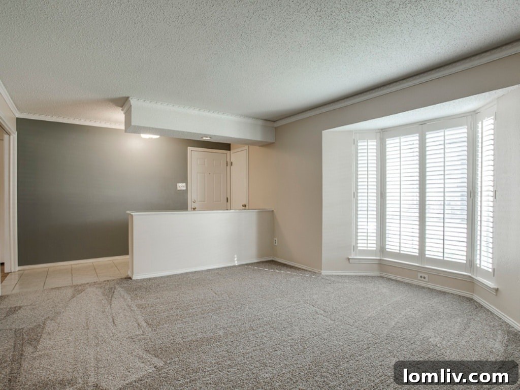 Interior view of a modern condo at 6009 Sandhurst Ln, Dallas, featuring new carpet and a bay window