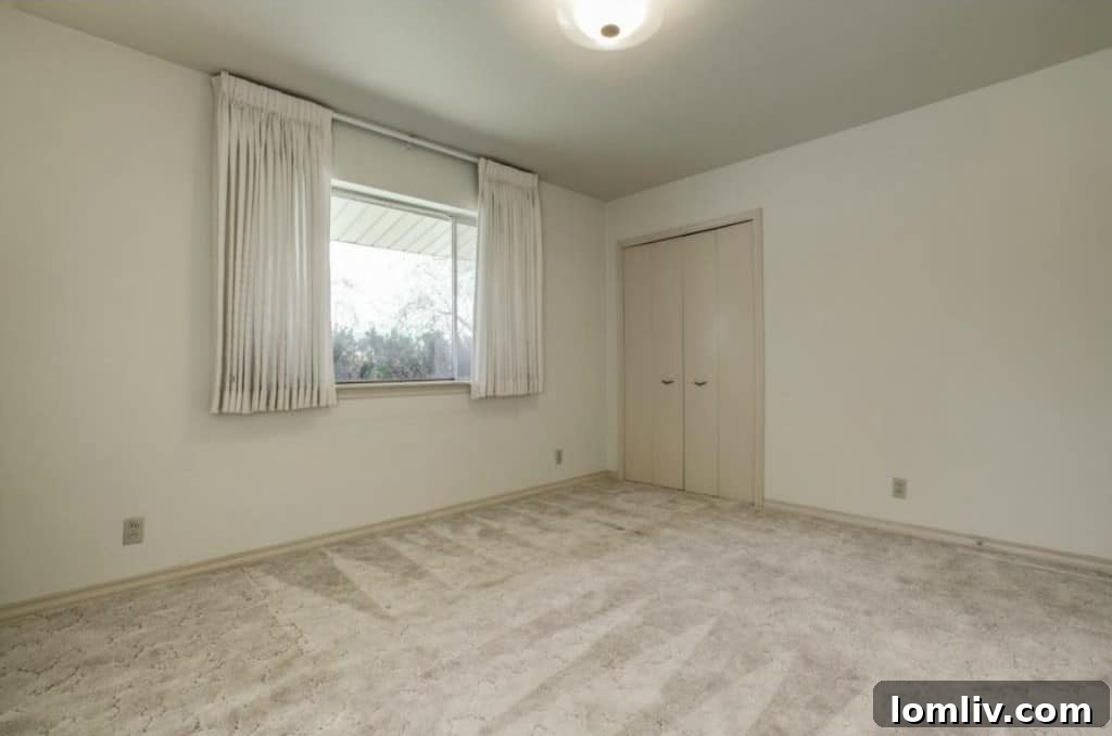 Master bedroom with built-in closets and vintage television