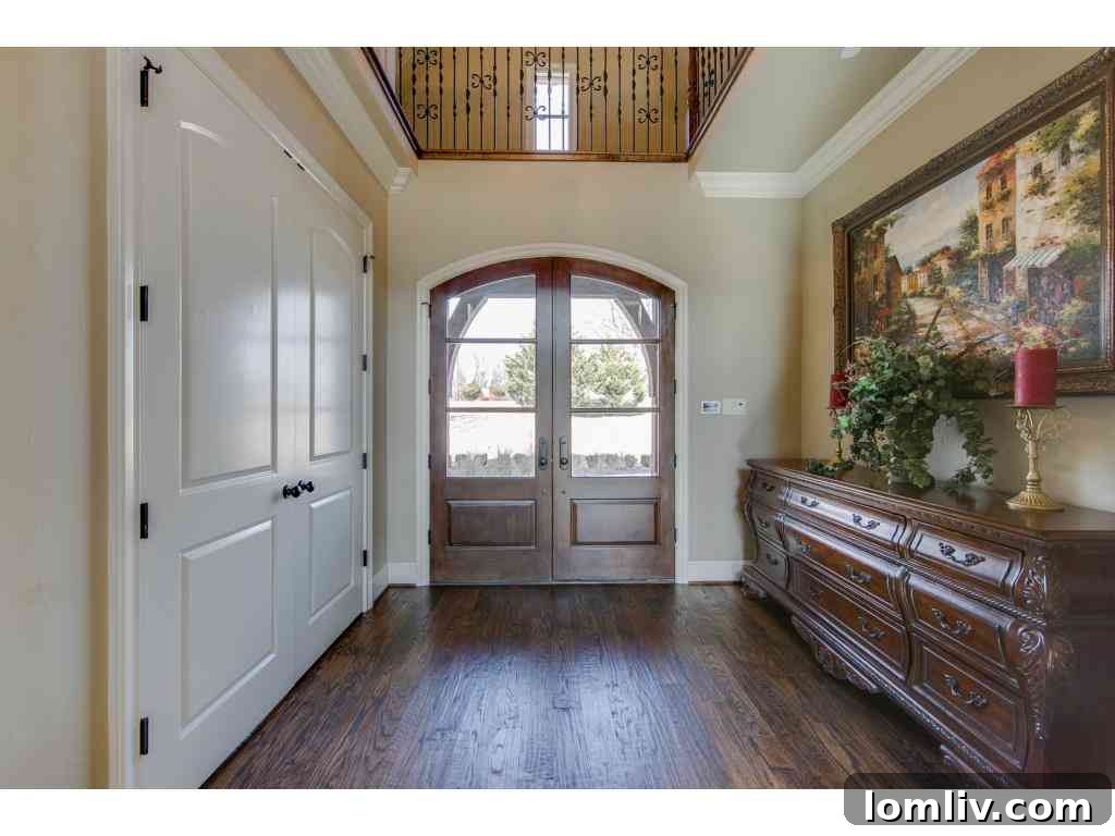 Elegant living room with custom fireplace, hardwood floors, and large windows offering natural light, 415 Blondy Jhune Road.