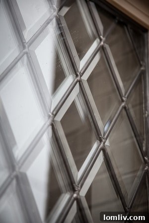 The cozy study in the Blythe home, featuring a traditional fireplace and elegant cut glass windows, perfect for quiet reflection.