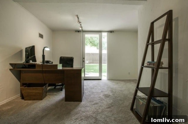 Office setup in the third bedroom with natural light
