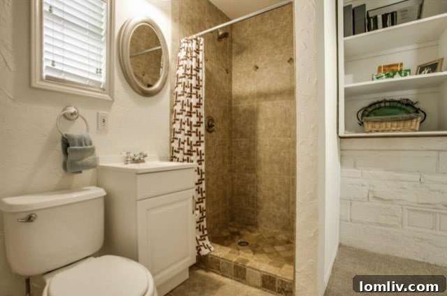 Second bathroom with shower and built-in shelving