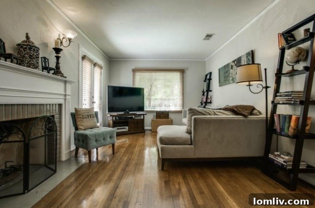 Spacious living room with fireplace and elegant crown molding