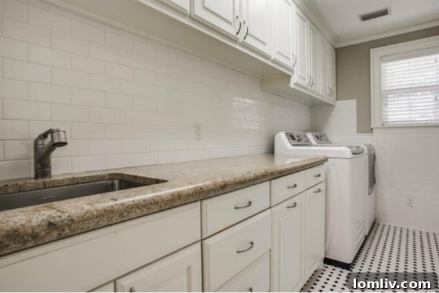 Luxurious utility room with matching kitchen finishes and ample storage