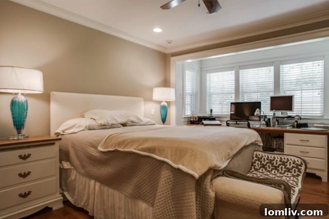 Spacious master bedroom with hardwood floors and recessed window