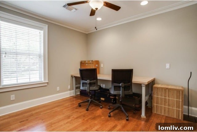 Second bedroom with ceiling fan and hardwood floors