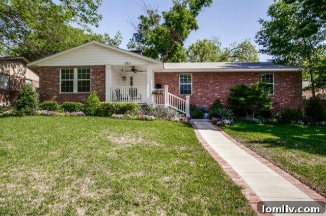 Front exterior of 9911 Estate Ln with brick-lined sidewalk and garden