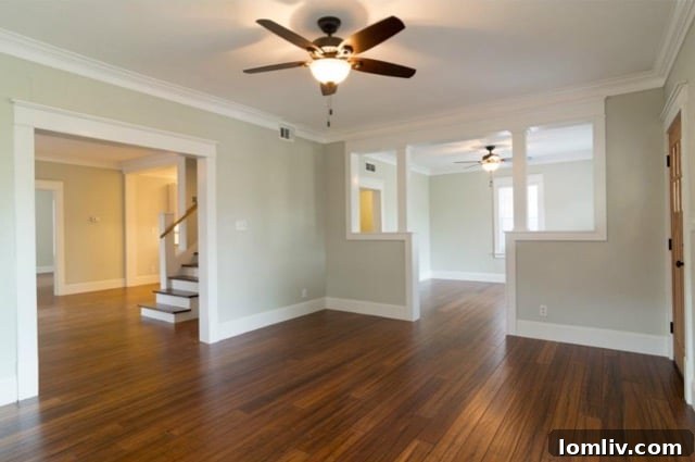 Living room with fireplace and columns leading to dining room
