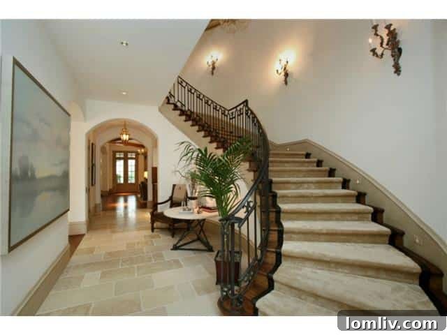 Troy Aikman's Normandy Home Under New Ownership 3 Elegant foyer of the French Normandy style home, featuring grand architectural details and inviting decor.