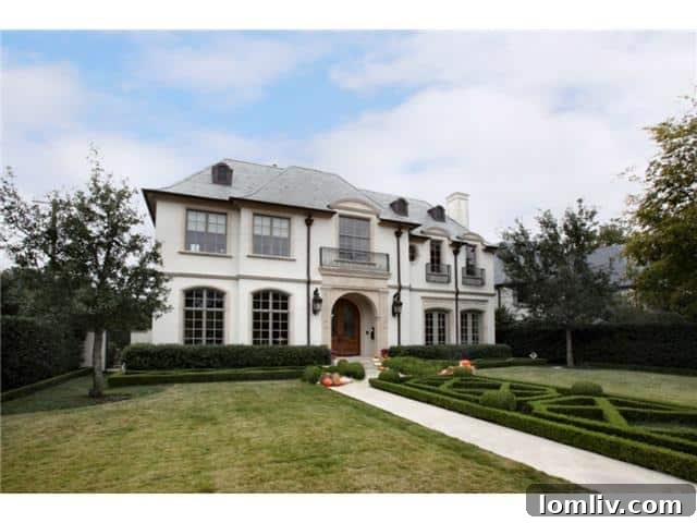 Troy Aikman's Normandy Home Under New Ownership 25 Another exterior perspective of Troy Aikman’s former home in Highland Park, highlighting its distinguished architecture and curb appeal.