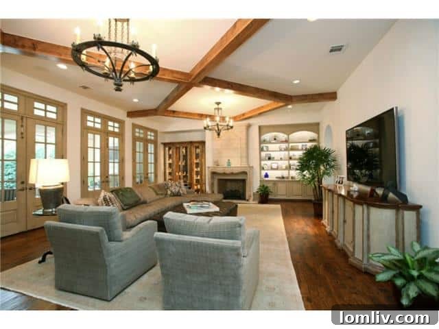 Troy Aikman's Normandy Home Under New Ownership 5 Inviting family room with a cozy fireplace, perfect for relaxation and informal gatherings.