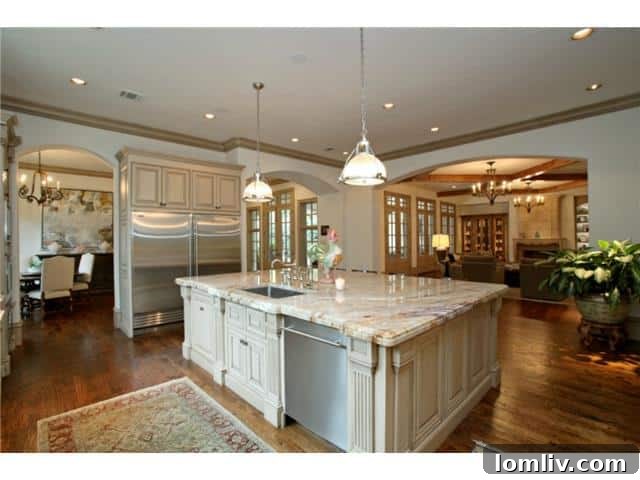 Troy Aikman's Normandy Home Under New Ownership 8 Gourmet kitchen, equipped with high-end appliances, custom cabinetry, and a large island, ideal for culinary enthusiasts.