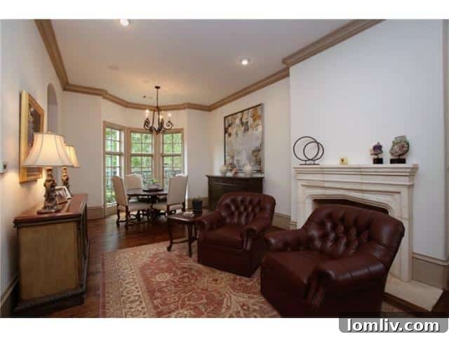 Troy Aikman's Normandy Home Under New Ownership 10 Bright morning room with a cozy fireplace, perfect for casual dining or a peaceful start to the day.