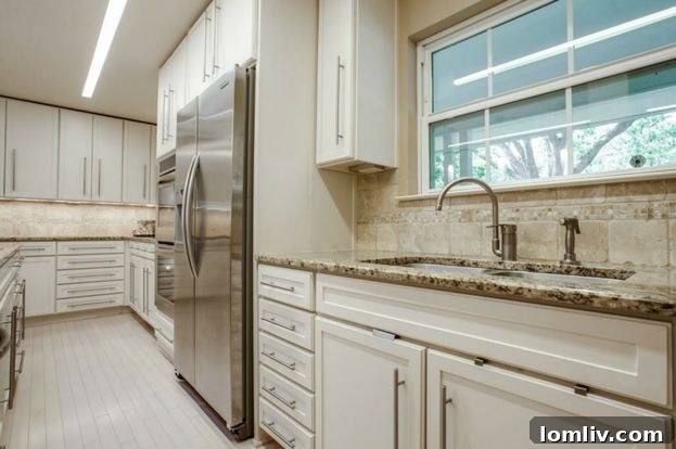 Updated kitchen with stainless steel appliances and granite countertops