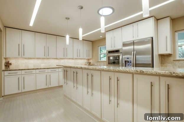 Dining area adjacent to the updated kitchen, showcasing modern lighting