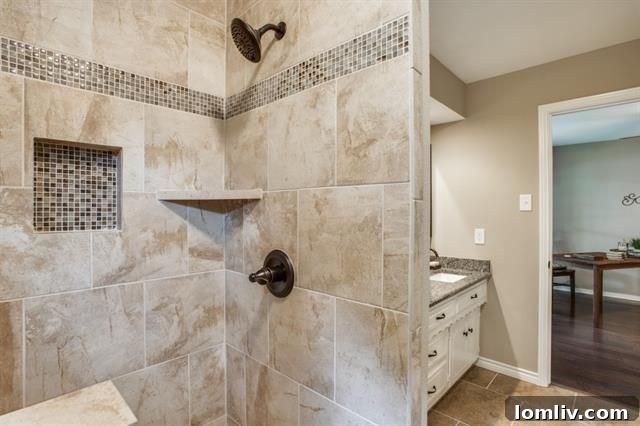 Luxurious walk-in shower in the master bathroom with bench and tiled niche