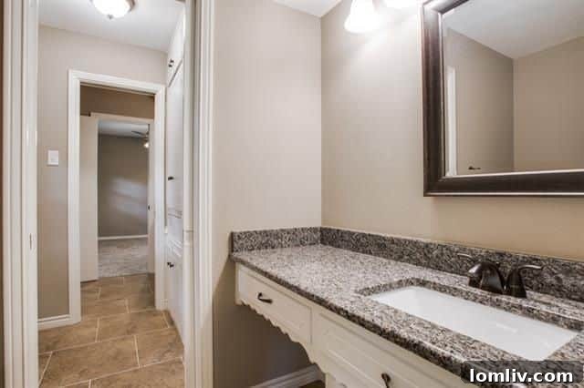 Updated upstairs bathroom mirroring the stylish renovation of the master bath