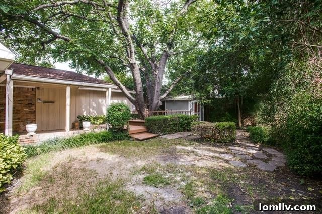 Spacious backyard with mature trees and a wooden deck