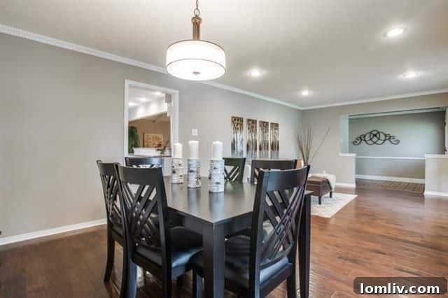 Spacious formal living room with large windows and laminate flooring