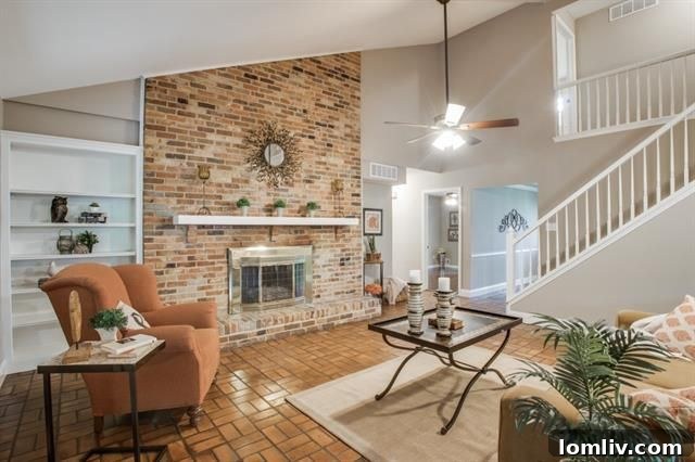 The impressive vaulted ceiling and brick fireplace in the main living room