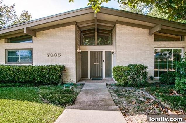 Bright living area with large windows in a Merriman Park midcentury modern home
