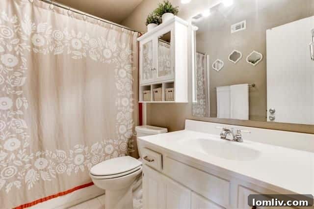 Master bedroom featuring a cozy fireplace and modern wallpaper