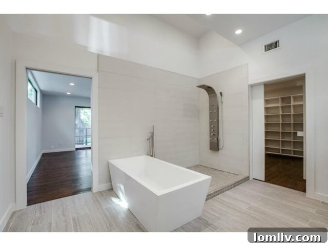 Luxurious Master Bathroom Featuring a Soaking Tub and Natural Light