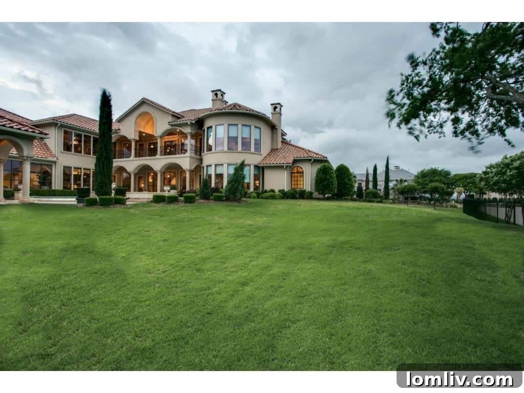The grand rear yard of the Kings Gate mansion, showcasing its expansive outdoor amenities.