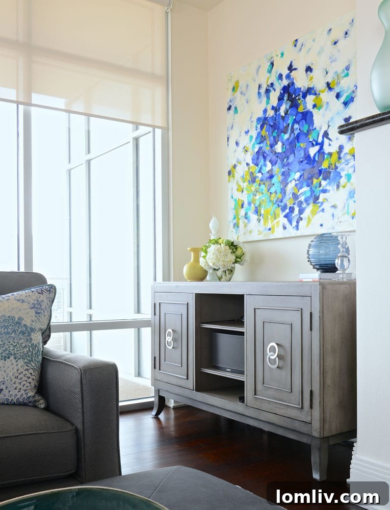 Contemporary media console with distressed silver finish in Dallas highrise