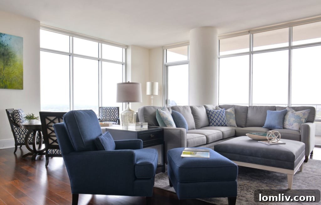 Living area in Dallas highrise with custom grey sectional and fireplace