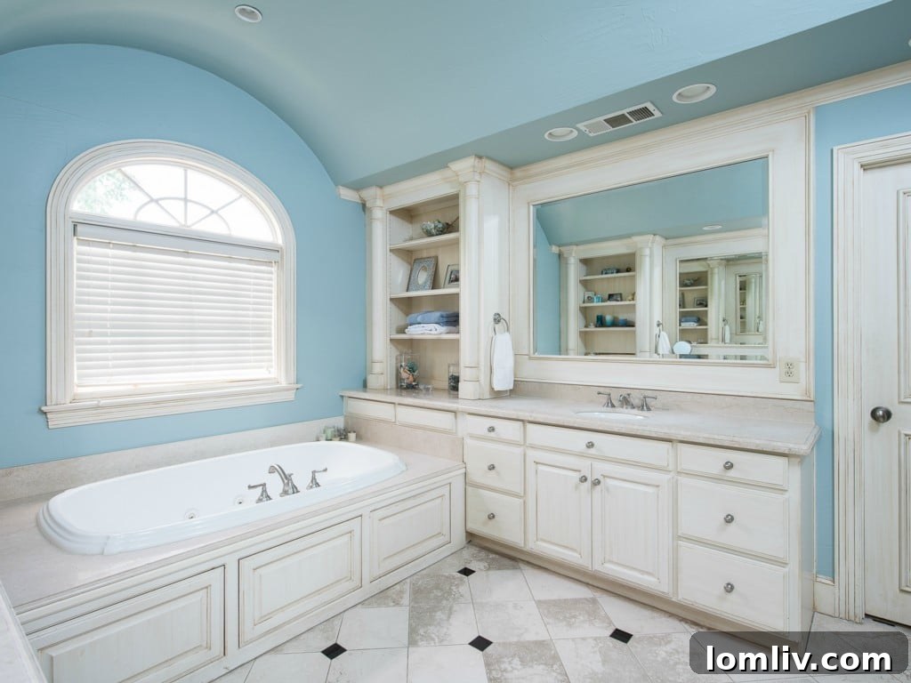 Spa-like master bathroom at 3325 Greenbrier, with a unique cove barrel ceiling, dual vanities, a large soaking tub, and a separate shower.
