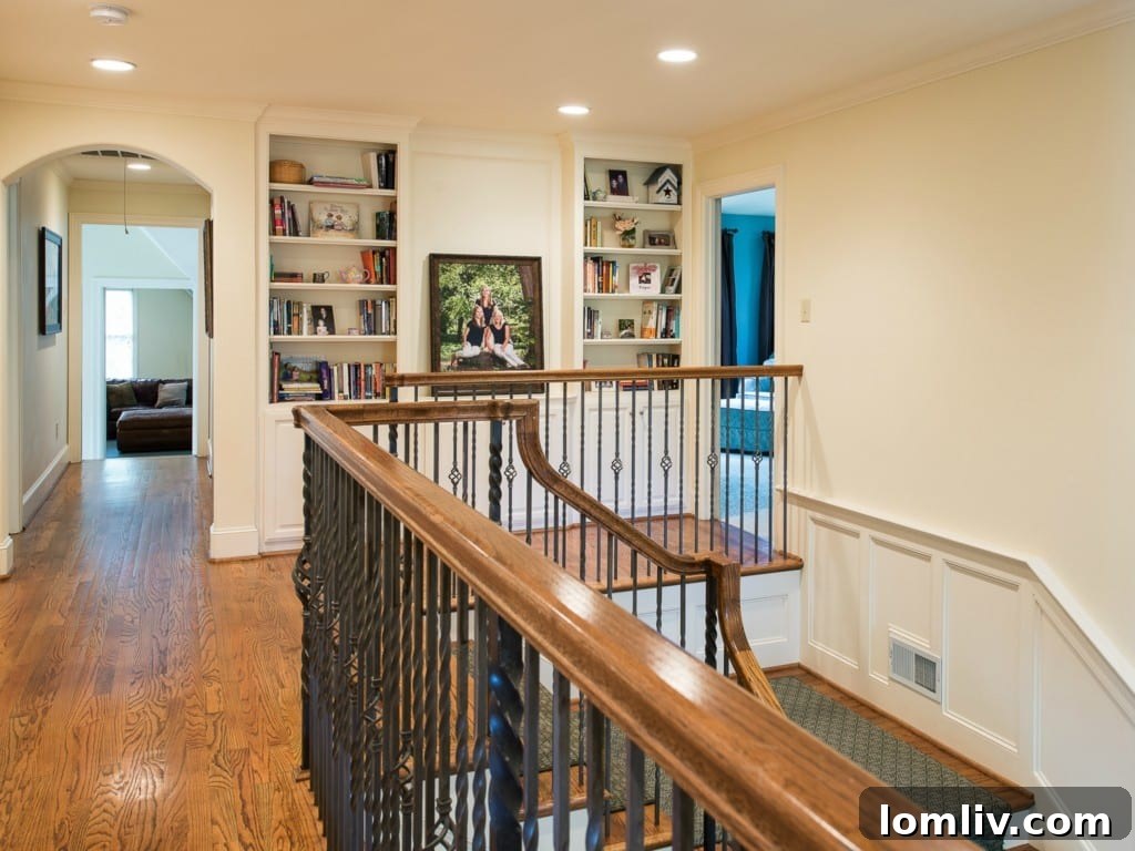Elegant landing area on the second floor of 3325 Greenbrier, showcasing architectural details, hardwood floors, and access to upstairs rooms.