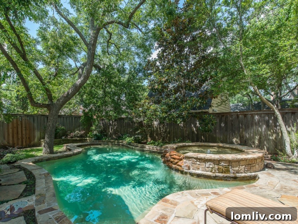 The charming rear exterior of 3325 Greenbrier, showcasing a well-maintained yard and classic architecture with a glimpse of the outdoor living space.