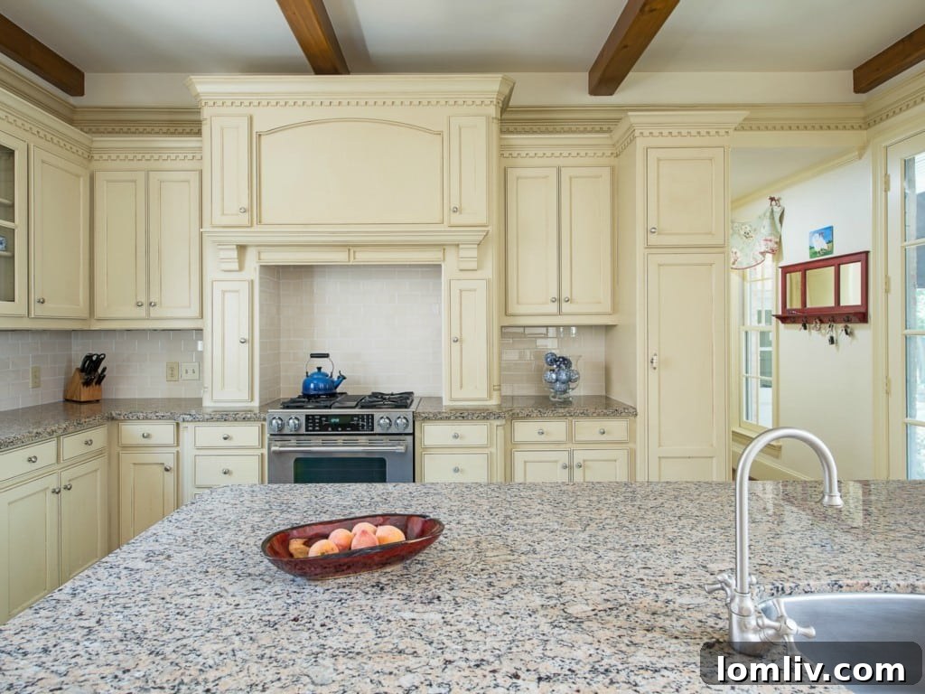 Another view of the gourmet kitchen in 3325 Greenbrier, highlighting the dual ovens, expansive counter space, and convenient island.