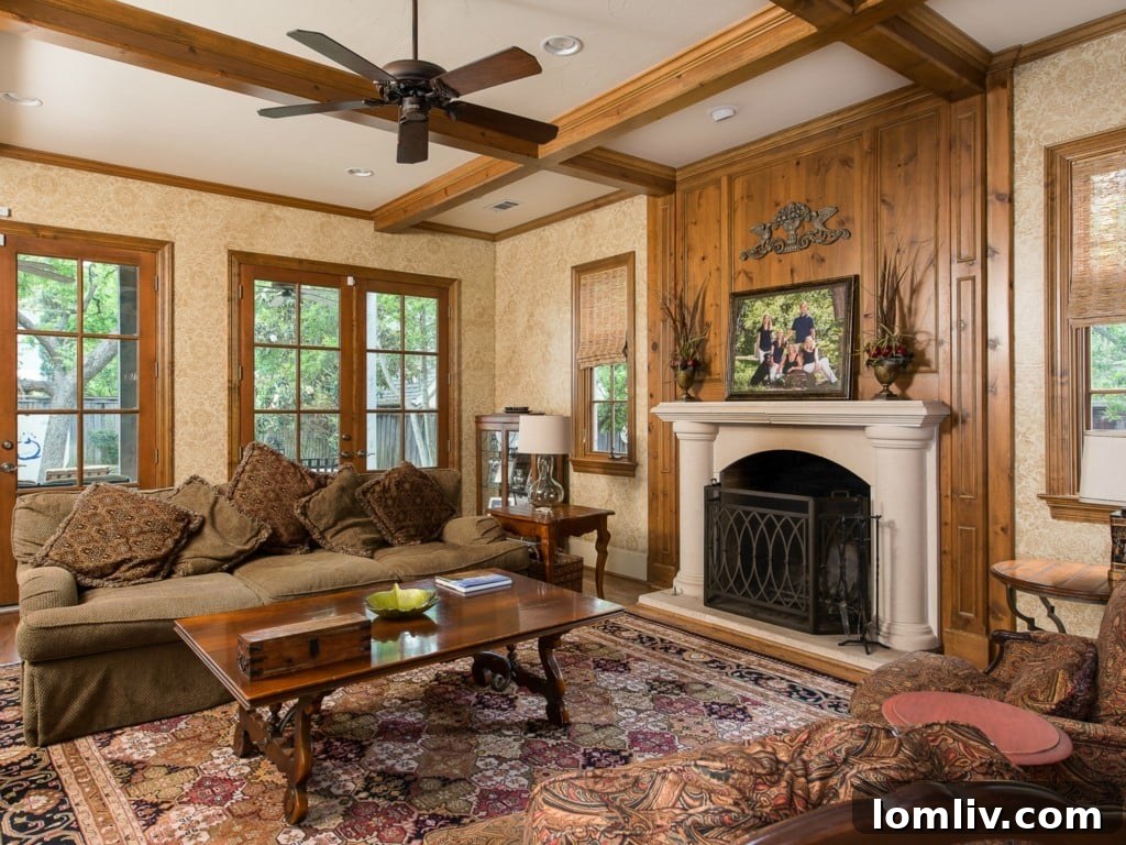 Comfortable family room at 3325 Greenbrier, a perfect gathering spot with a cozy fireplace, built-in shelving, and large windows.