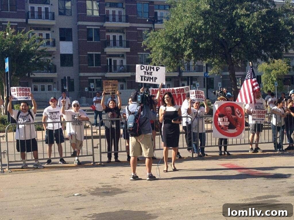 Protesters holding 'Dump Trump' signs, expressing strong opposition to his political agenda outside the rally.