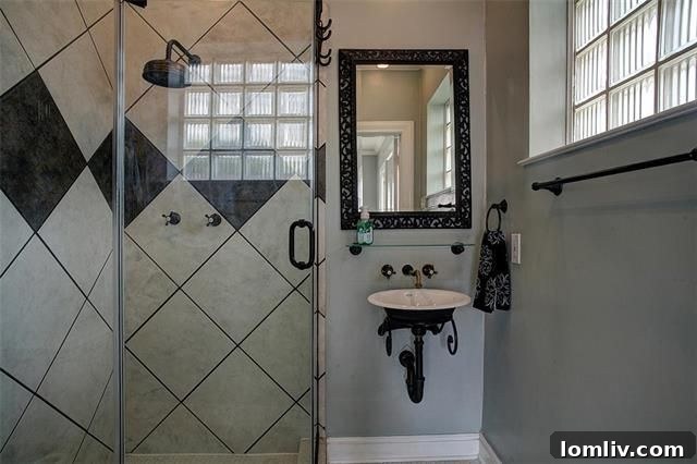Detail of the frameless glass shower in one of the updated bathrooms
