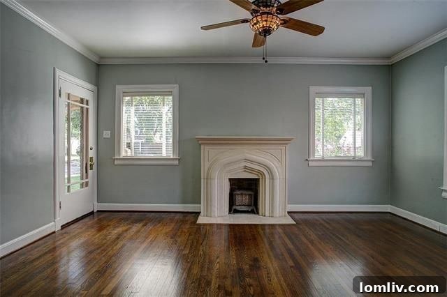 Interior view of the living room at 510 Cordova Street featuring an original fireplace and arched doorway